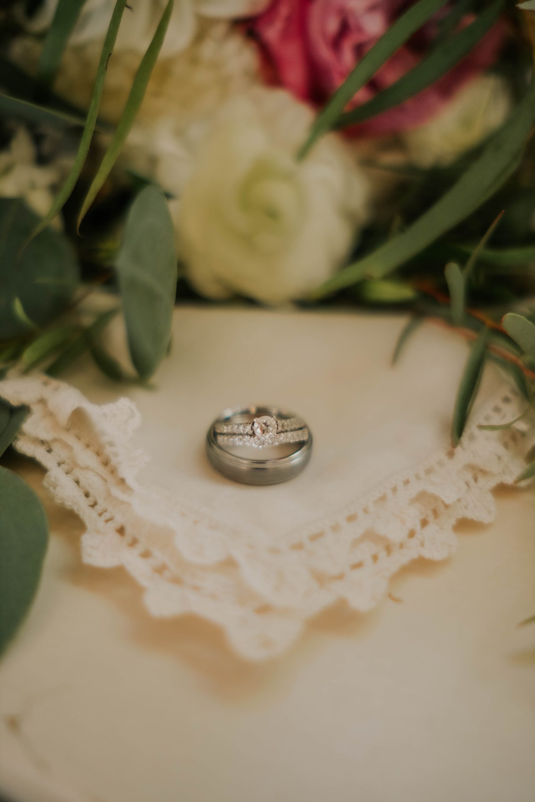 wedding rings rest on lace handkerchief