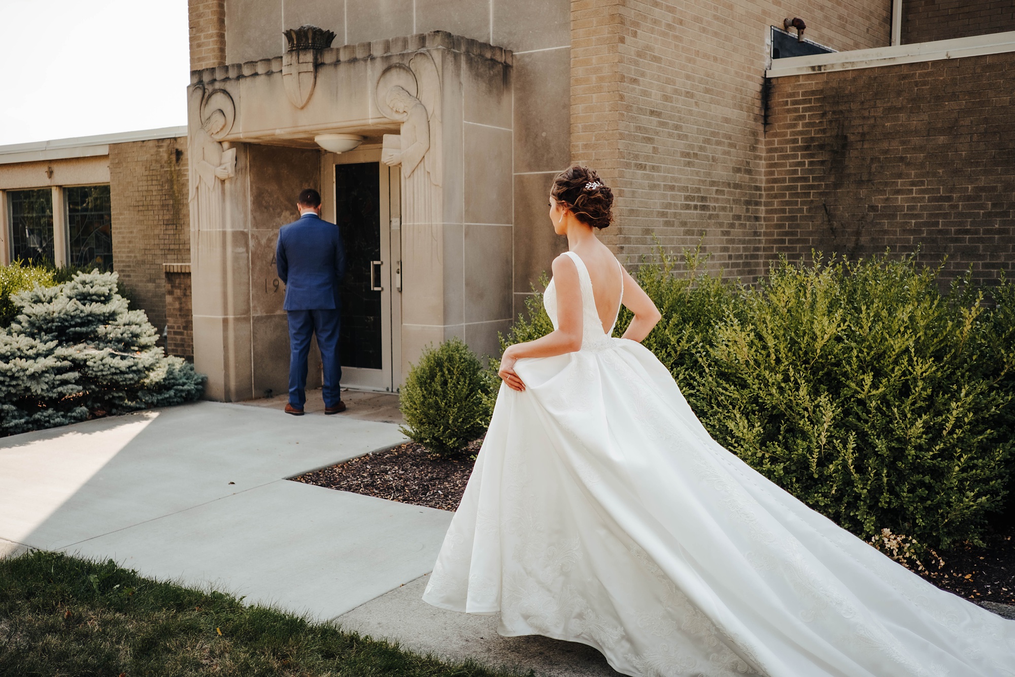 bride approaches groom for first look outside church