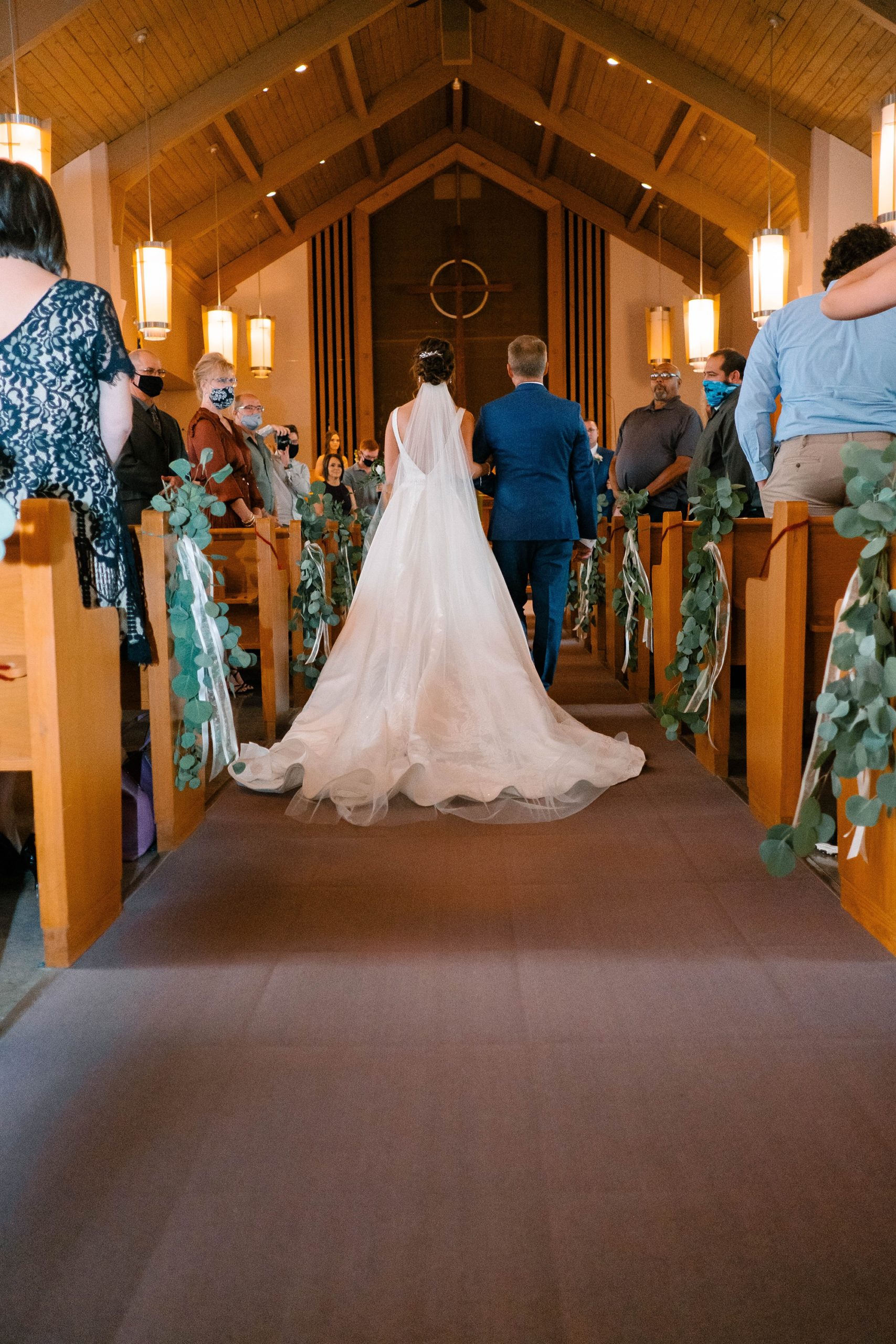 couple walks up aisle during traditional church wedding in Ohio