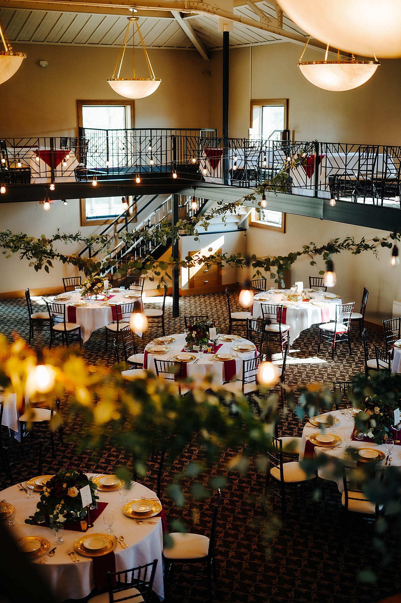 wedding reception in Nazareth Hall with greenery draped on staircase