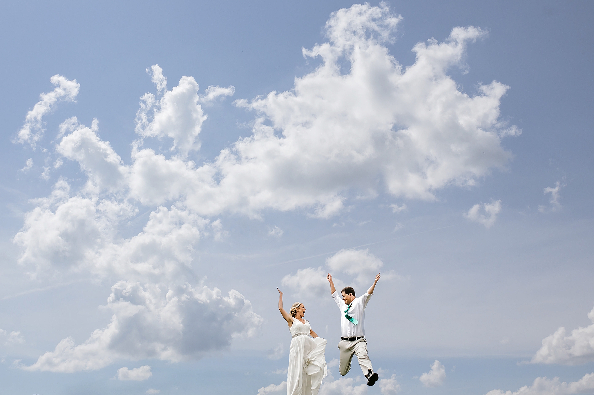 couple jumps during Ohio wedding photos